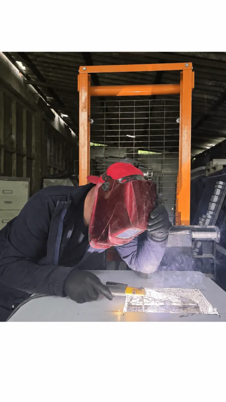 A COIN technician welding in the Prishtinë workshop